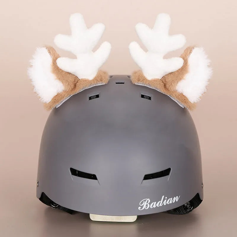 Plush fabric ski helmet decoration with cartoon design on a black ski helmet.