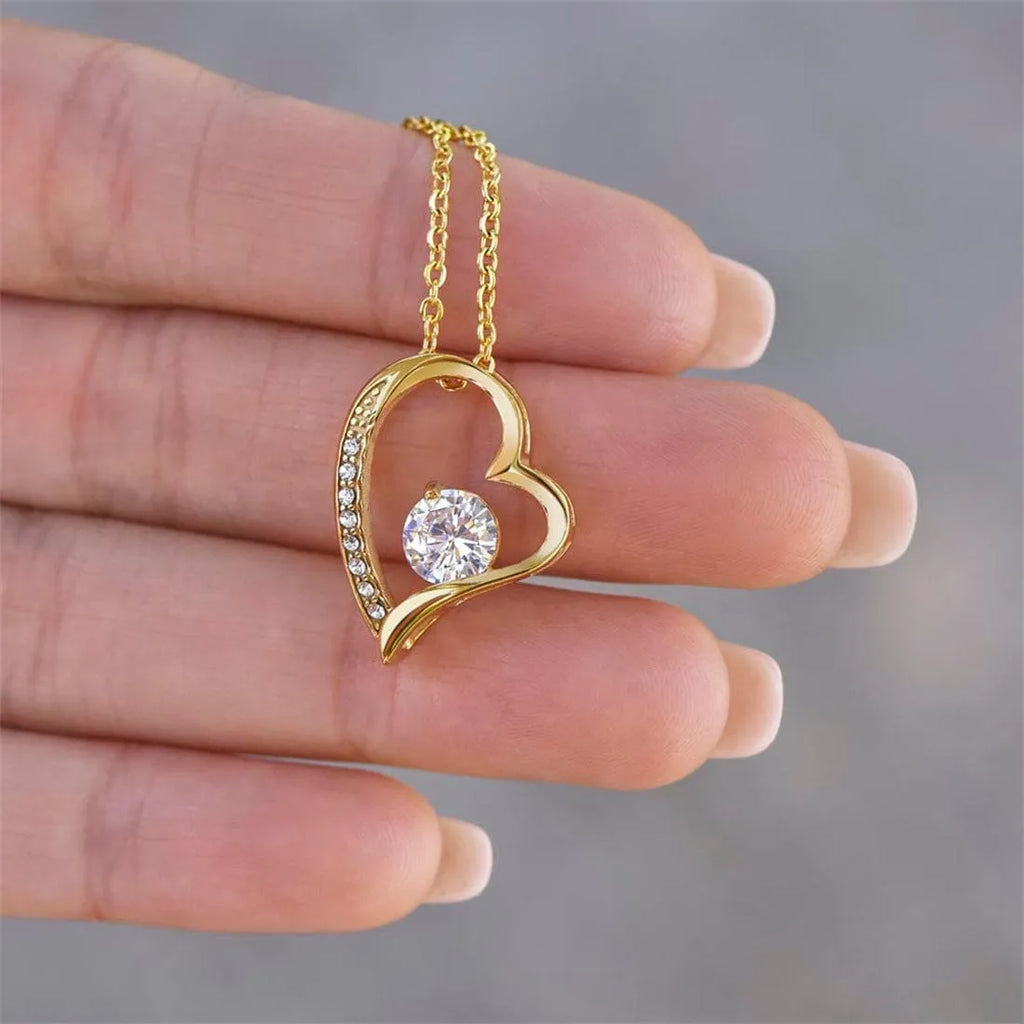 Hollow heart-shaped pendant necklace in silver or gold tone with mixed material construction and gift packaging