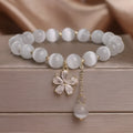 White cat's eye stone bracelet with flower tassel design and morganite safety buckle