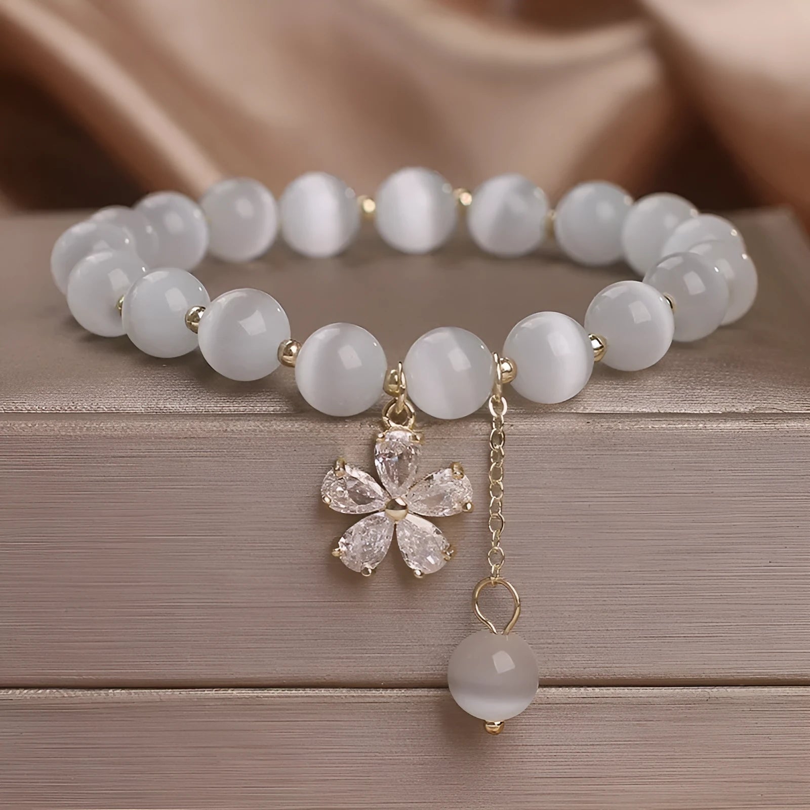 White cat's eye stone bracelet with flower tassel design and morganite safety buckle