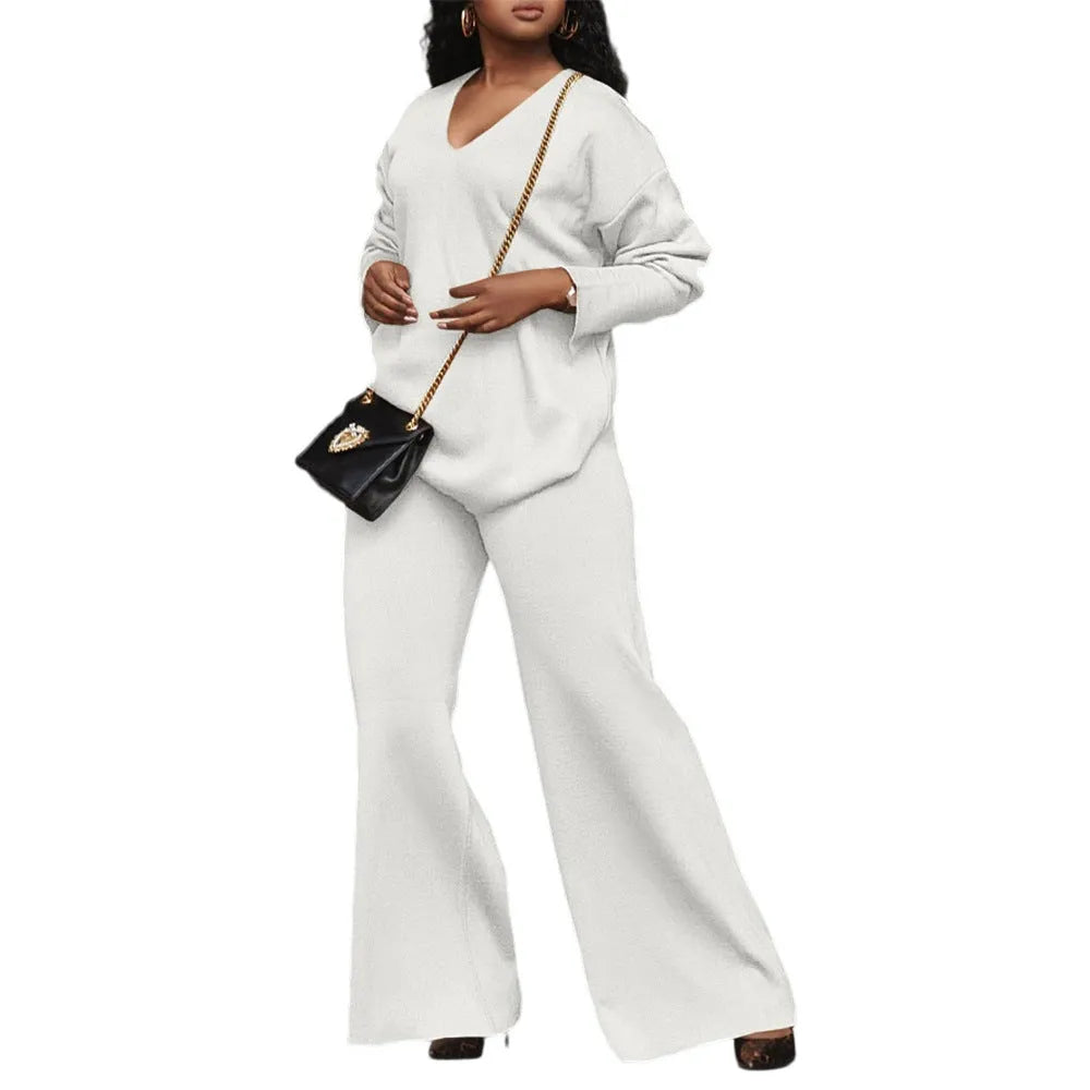 Women's brown suede two-piece suit with split sleeve detail on the long-sleeved top and matching trousers.