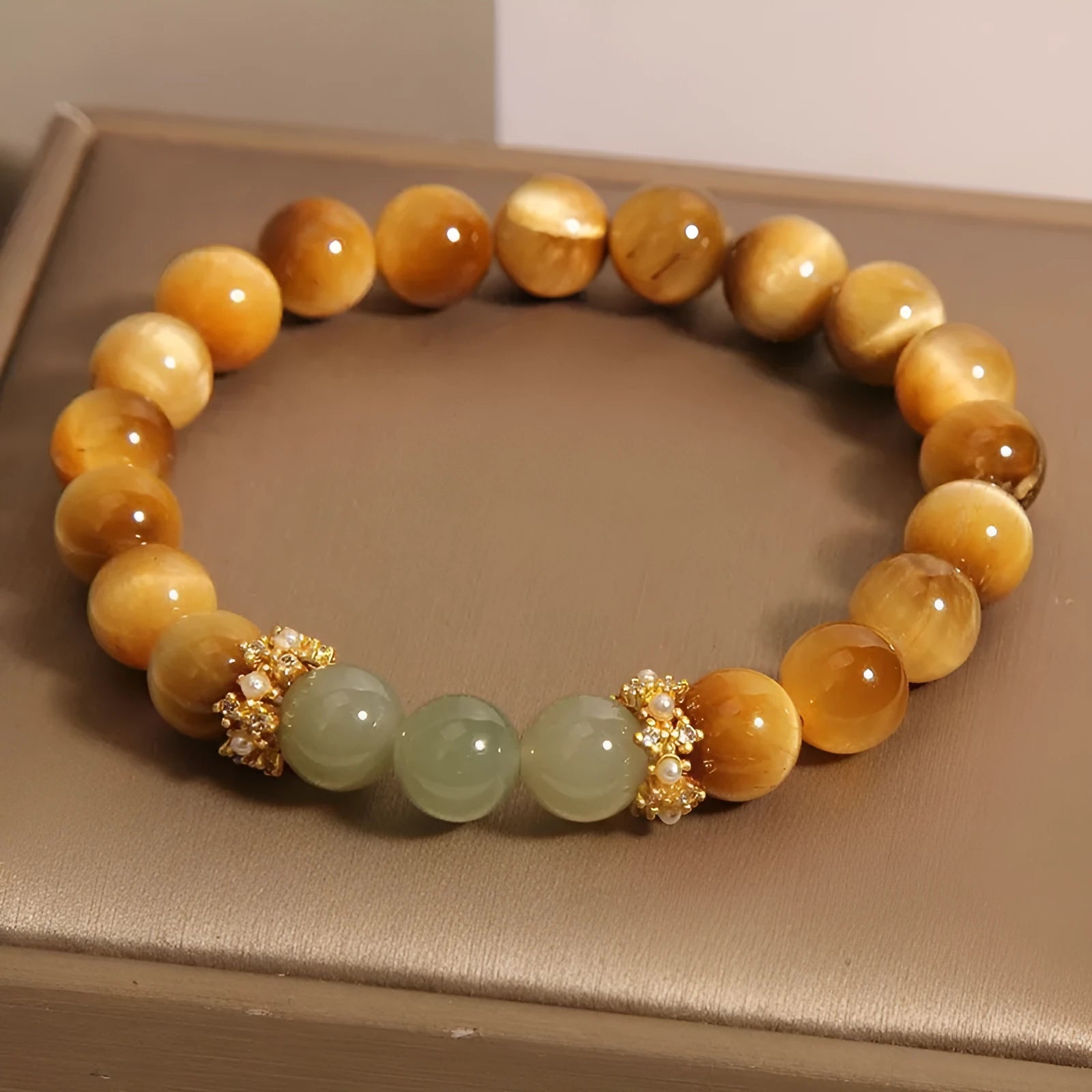 Natural yellow Tiger's Eye Hetian Jade bracelet in U-shape with gold gourd charm.