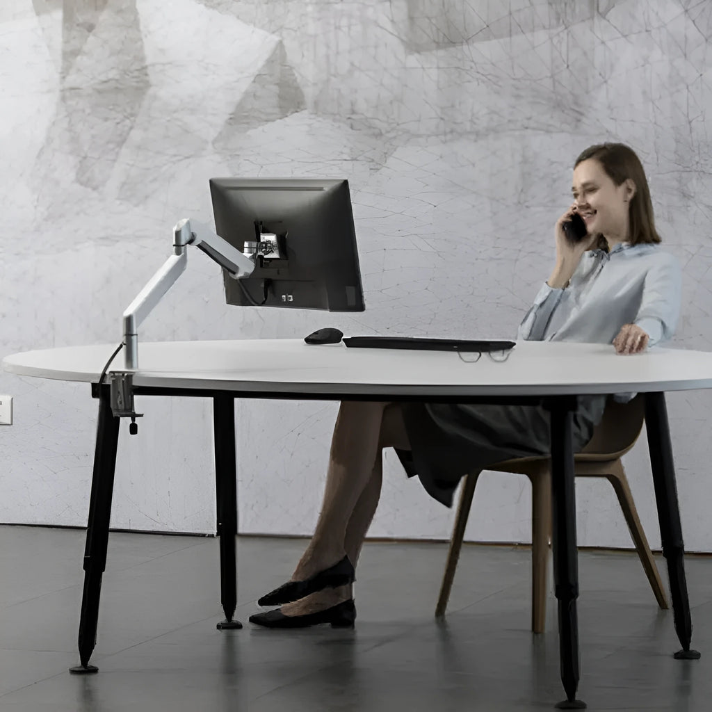 Silver aluminium alloy laptop stand with air pressure arm bracket on desktop