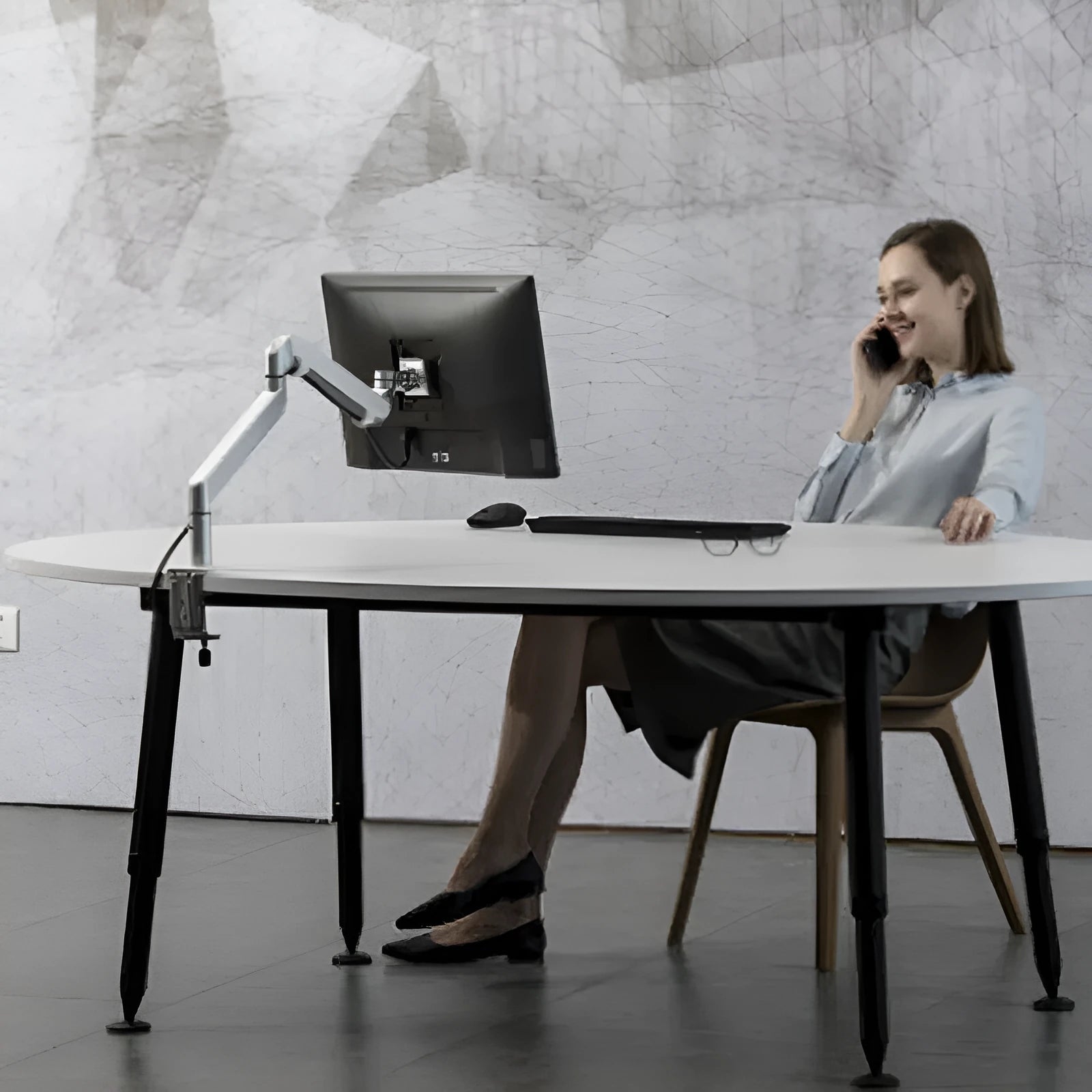 Silver aluminium alloy laptop stand with air pressure arm bracket on desktop