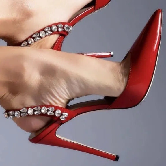 Women's black patent leather pointed toe stiletto sandals with rhinestone decorations along the side.