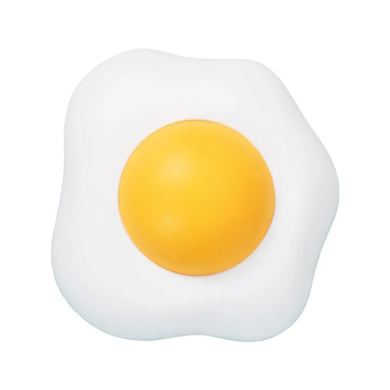 Soft plush catnip ball toy with suction cup mounted on a wall, shown in fried egg and poached egg shapes.