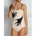 Women's one-piece bikini swimsuit with a gauze skirt cover-up.