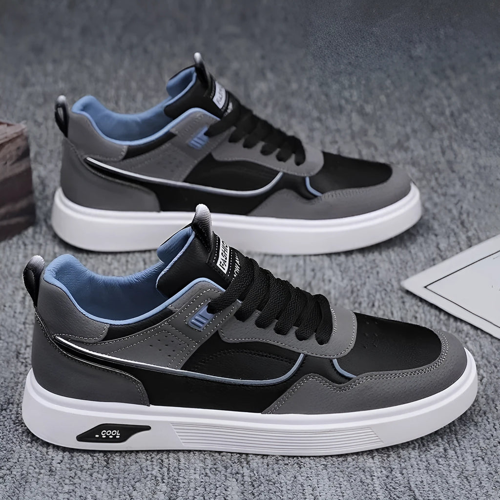 Men's low-top canvas shoes in black with leather stitching and mesh lining, shown on a white background.