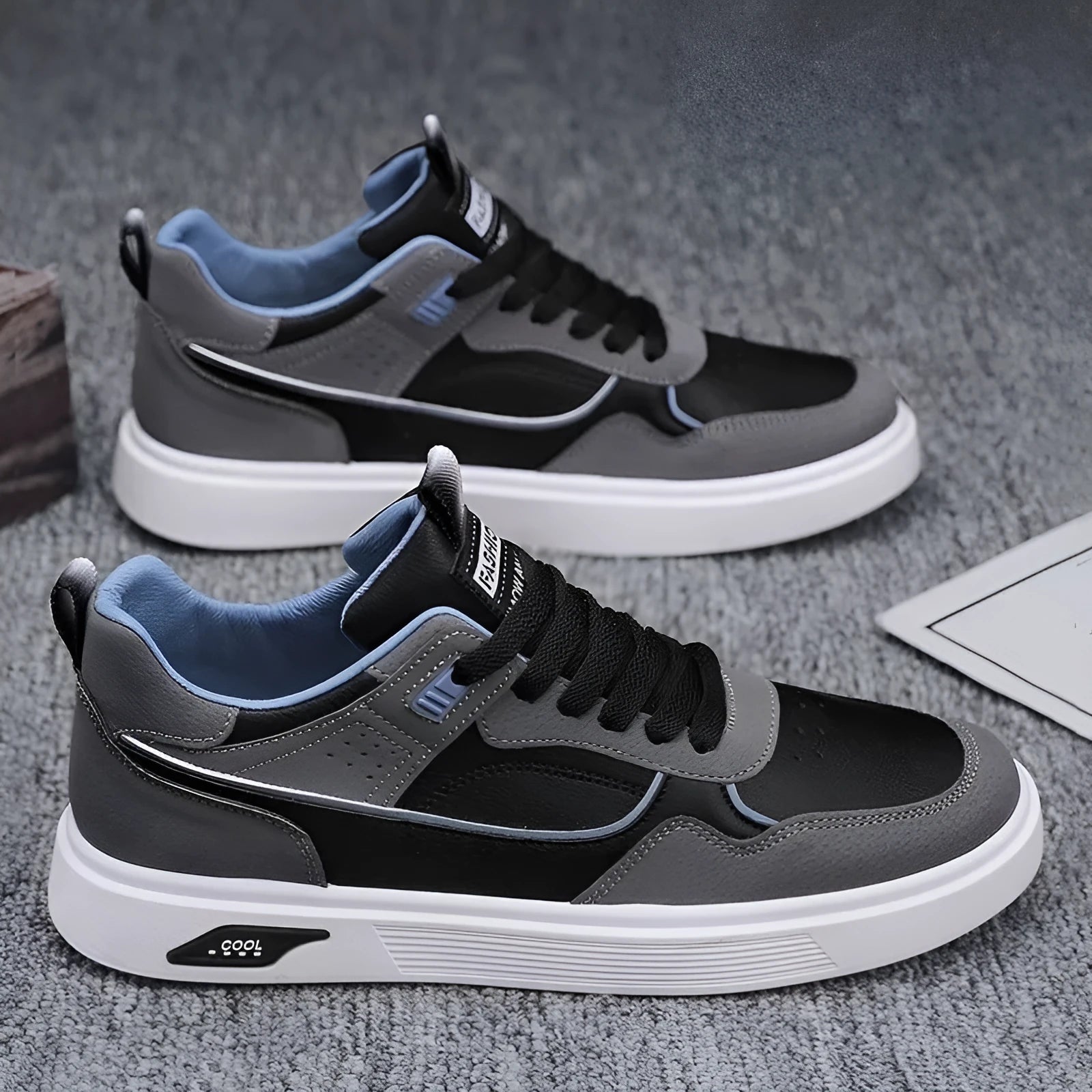 Men's low-top canvas shoes in black with leather stitching and mesh lining, shown on a white background.