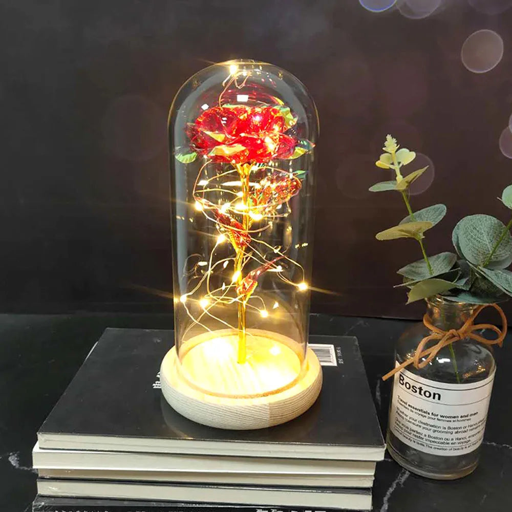 LED rose ornament with silk flowers under glass shade, showing colour options on a wooden base.