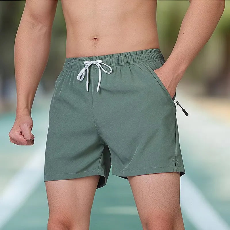 Black micro-elastic polyester men's training shorts with high waist and drawstring, laid flat.