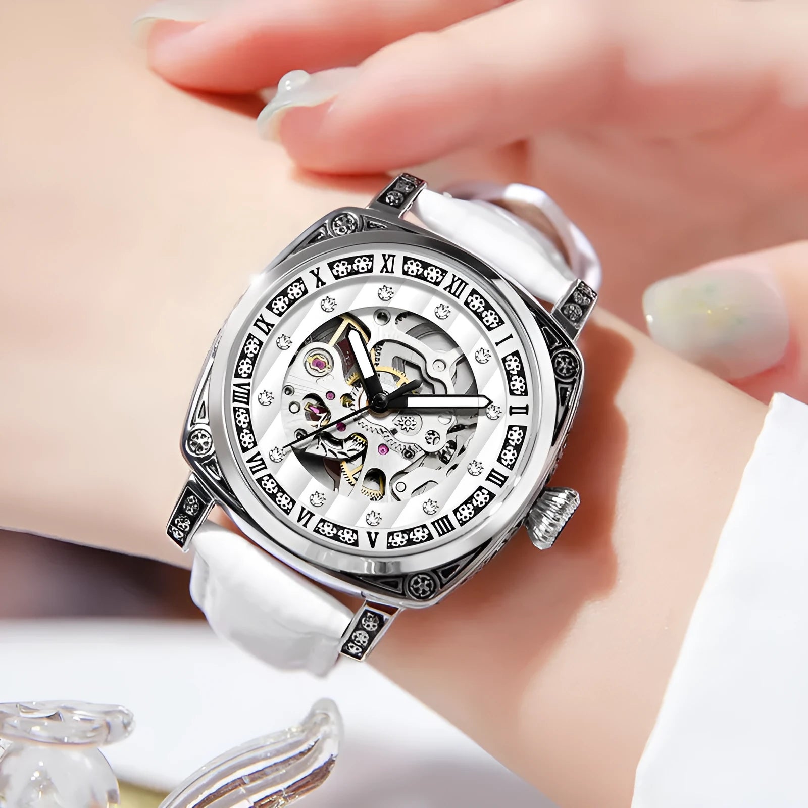 Mechanical watch with luminous hands and leather strap in choice of colours.