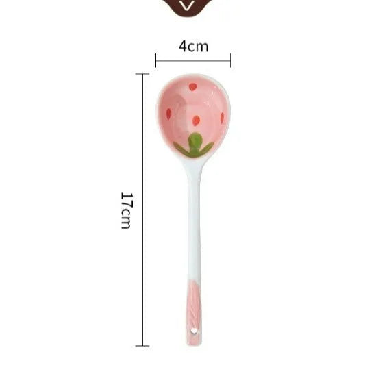 Porcelain dinnerware set with strawberry design showing plates, flower bowls, and twist spoon