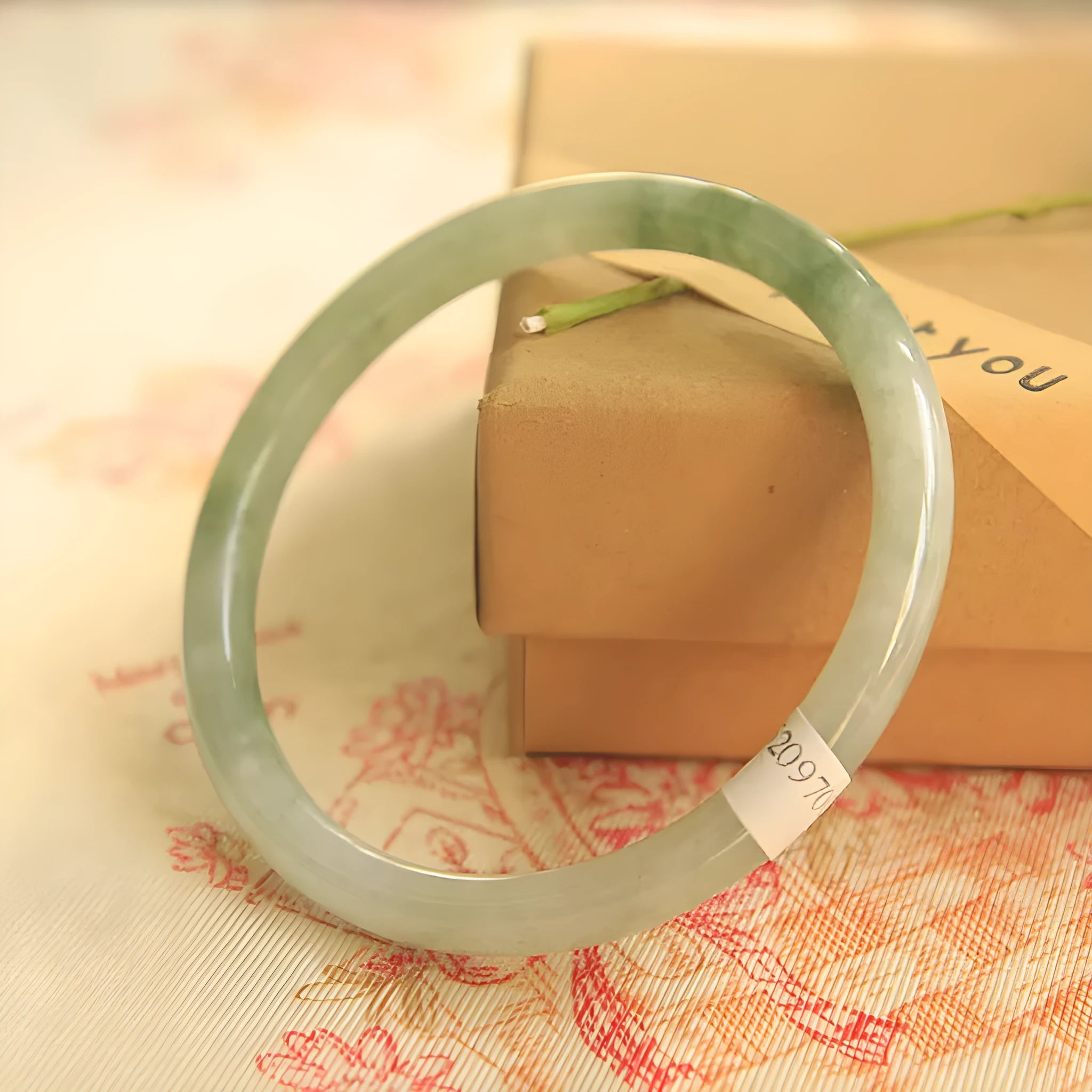 Green jade geometric bracelet with waxy finish showing 10mm width and adjustable sizing