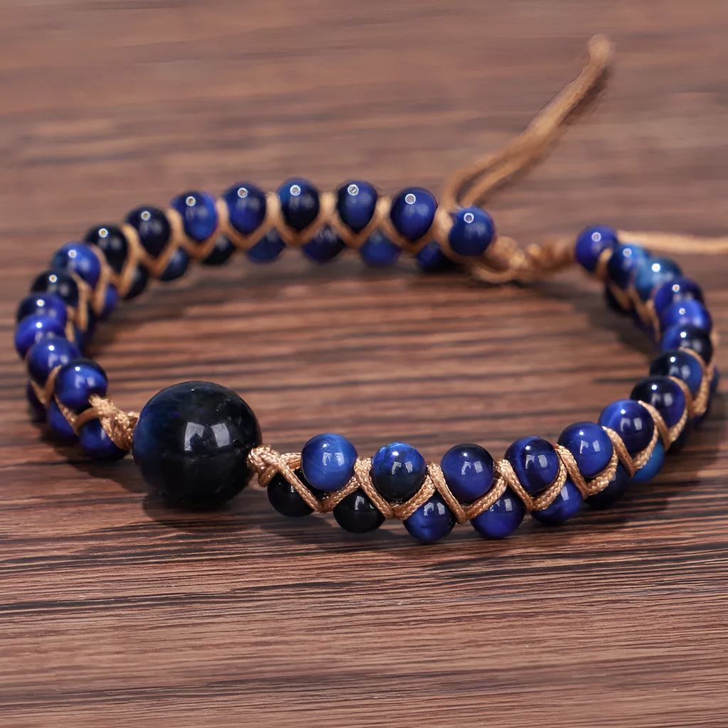 Handmade woven geometric bracelet with a blue Tigereye stone bead and pull design.