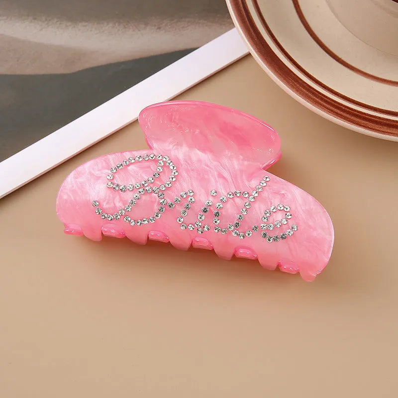 Pink and white acrylic barrette hair clip with diamond spot drilling and English letters.