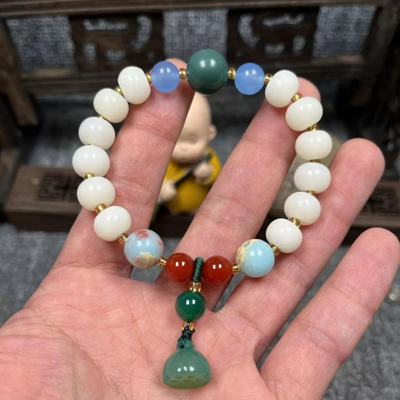 Carved pumpkin lotus bodhi root bracelet with white jade segments and golden silk jade treasures
