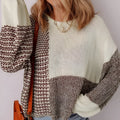 Dark khaki colour block loose sweater with back tie and drop shoulders on a hanger.