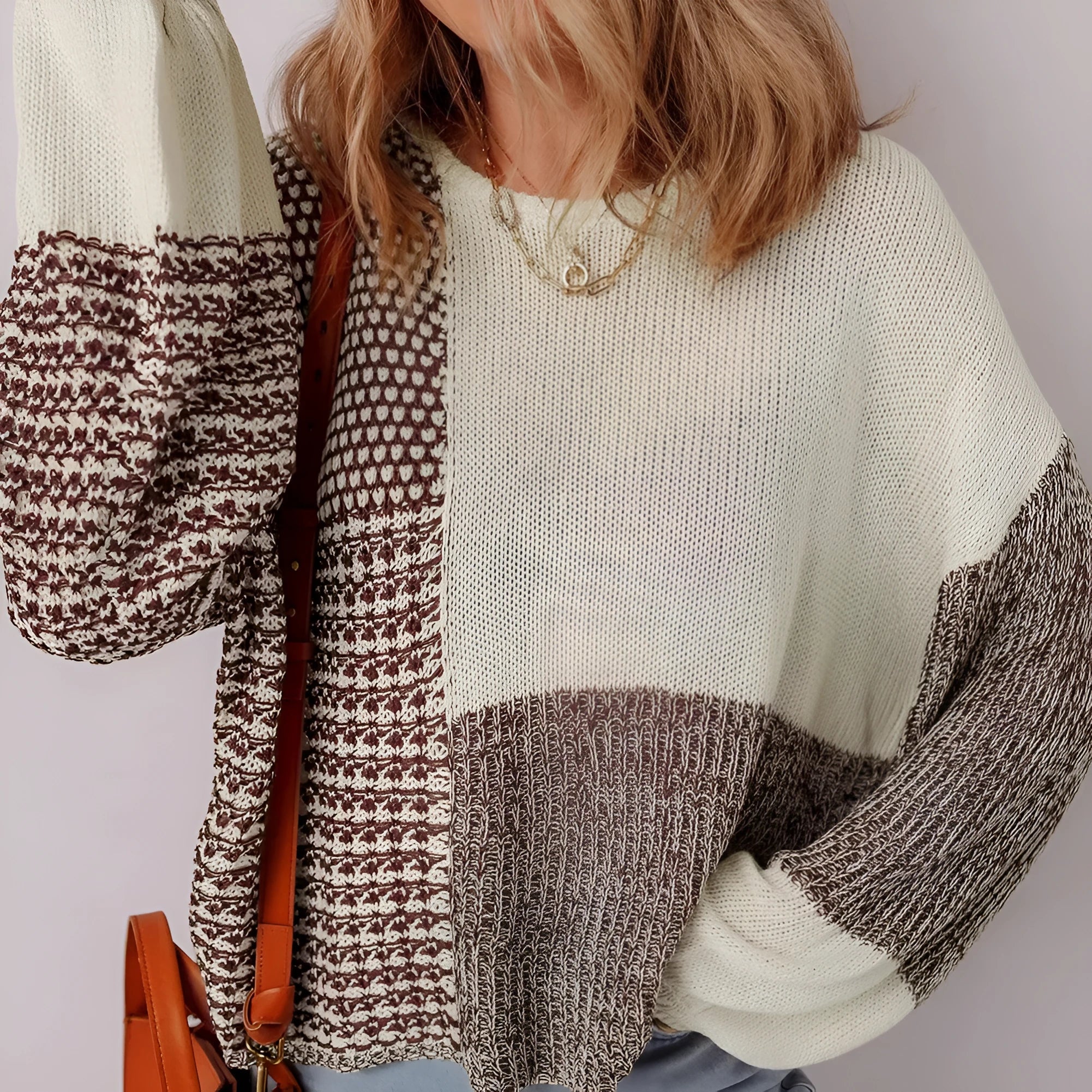 Dark khaki colour block loose sweater with back tie and drop shoulders on a hanger.