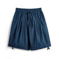 Men's loose fit nylon summer shorts in Prussian blue with embroidered design detail