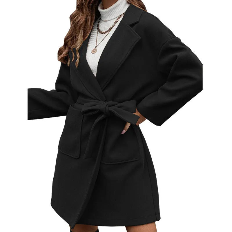 Minimalist long sleeve belted coat in thick polyester fabric shown in a light blue colour.