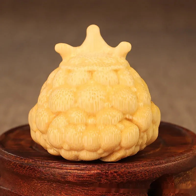 Close-up of a 5 cm cute Crown Princess Toad ornament carved from solid bamboo.