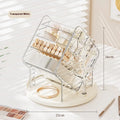 Clear and amber gold rotating cosmetics storage box organiser on a table.