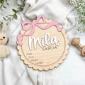 Square wooden baby room ornament with a custom engraved name, shown in two size options.