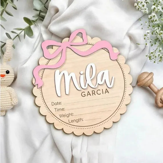 Square wooden baby room ornament with a custom engraved name, shown in two size options.