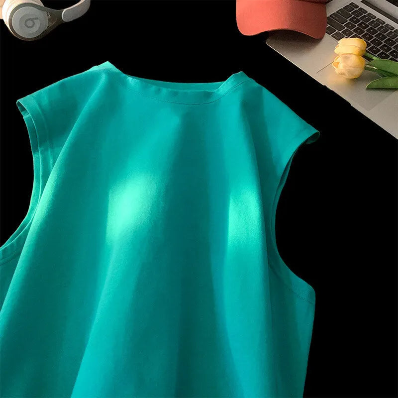 Men's loose cotton tank top in solid colours showing sleeveless design and straight hem