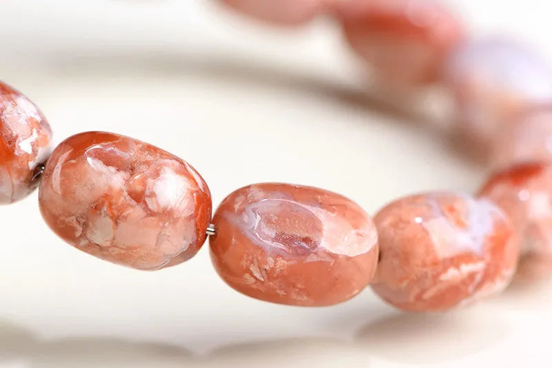 Natural cherry agate bracelet with barrel-shaped beads and ruyi design elements