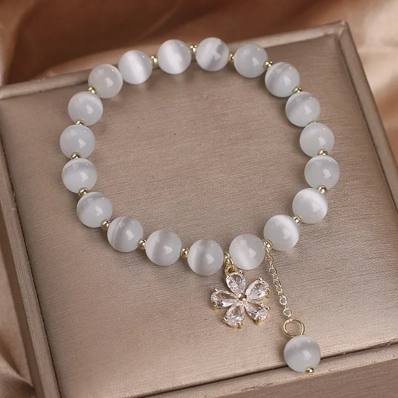 White cat's eye stone bracelet with flower tassel design and morganite safety buckle