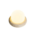 Cream colour bedside night lamp with remote control on wooden bedside table