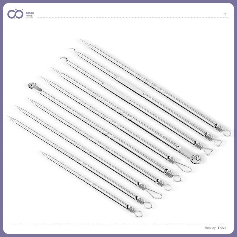 Four silver metal acne needles with pointed tips laid out on a flat surface.