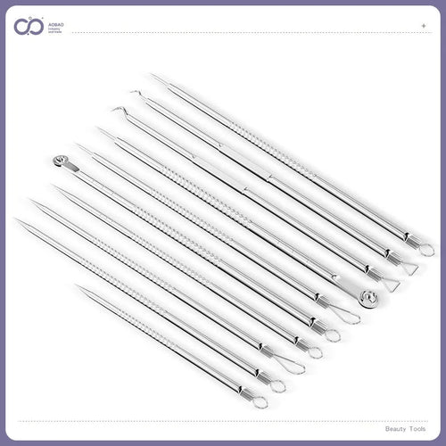 Four silver metal acne needles with pointed tips laid out on a flat surface.