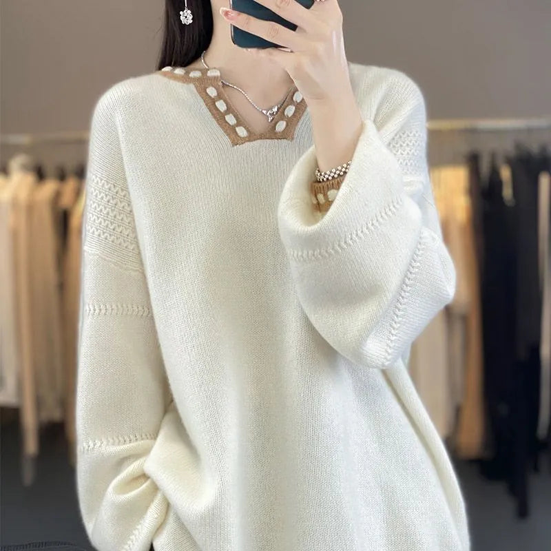 Women's camel and white V-neck viscose pullover sweater with long sleeves.