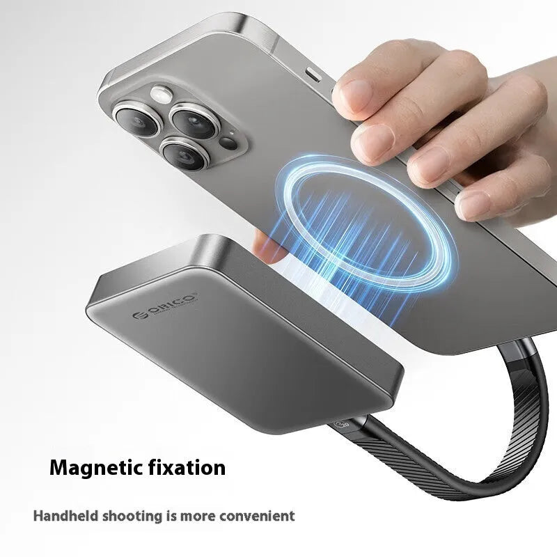 Grey magnetic mobile solid state drive with C to C cable and magnetic ring on a dark surface.