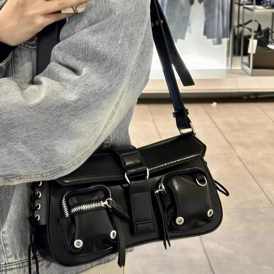 Black women's shoulder messenger bag with adjustable strap showing zippered change compartment interior