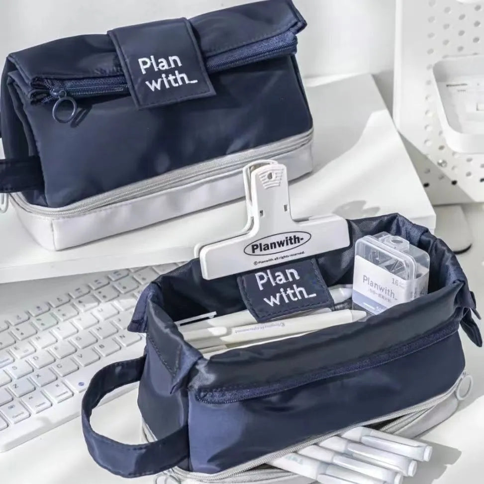 Folding double-layer polyester pencil case in dark blue, blue, and cream white colours with organised compartments