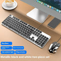 Wired computer keyboard with mute button and blue backlighting on a desk