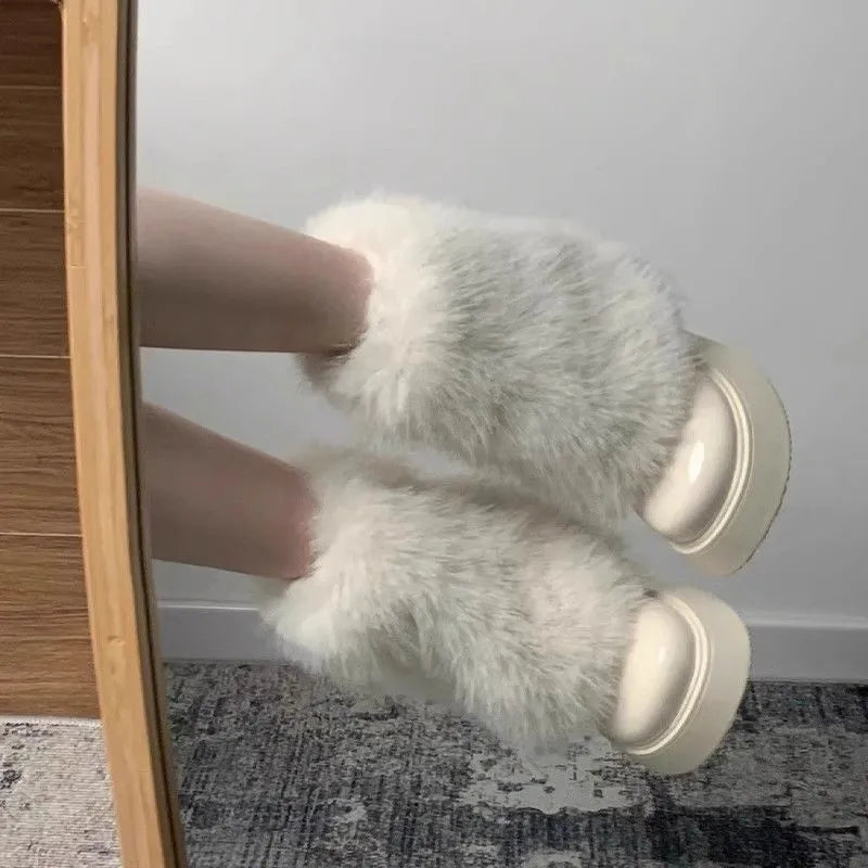 Women's black artificial plush snow boots with a round toe, low-top design, and a mid rubber sole.