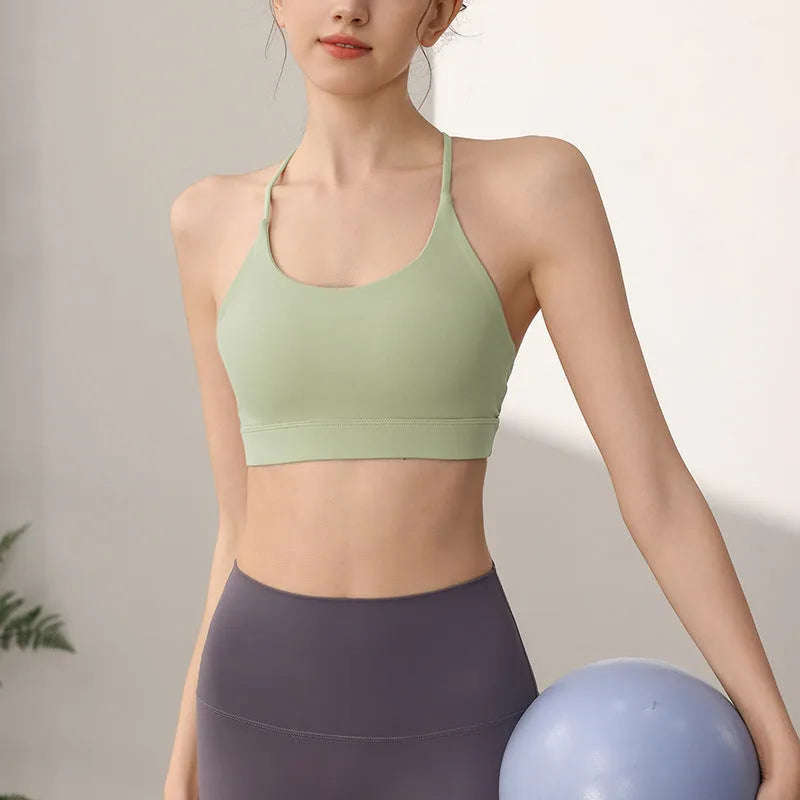Women's black nylon sports vest with double shoulder straps for running and gym workouts.
