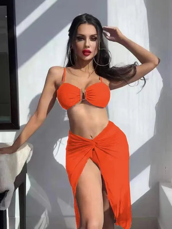 Women's multicolour French-style three-piece bikini set with a long culotte skirt on a hanger.
