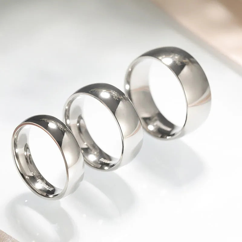 Silver-coloured titanium steel ring shown in minimalist style with unisex sizing.