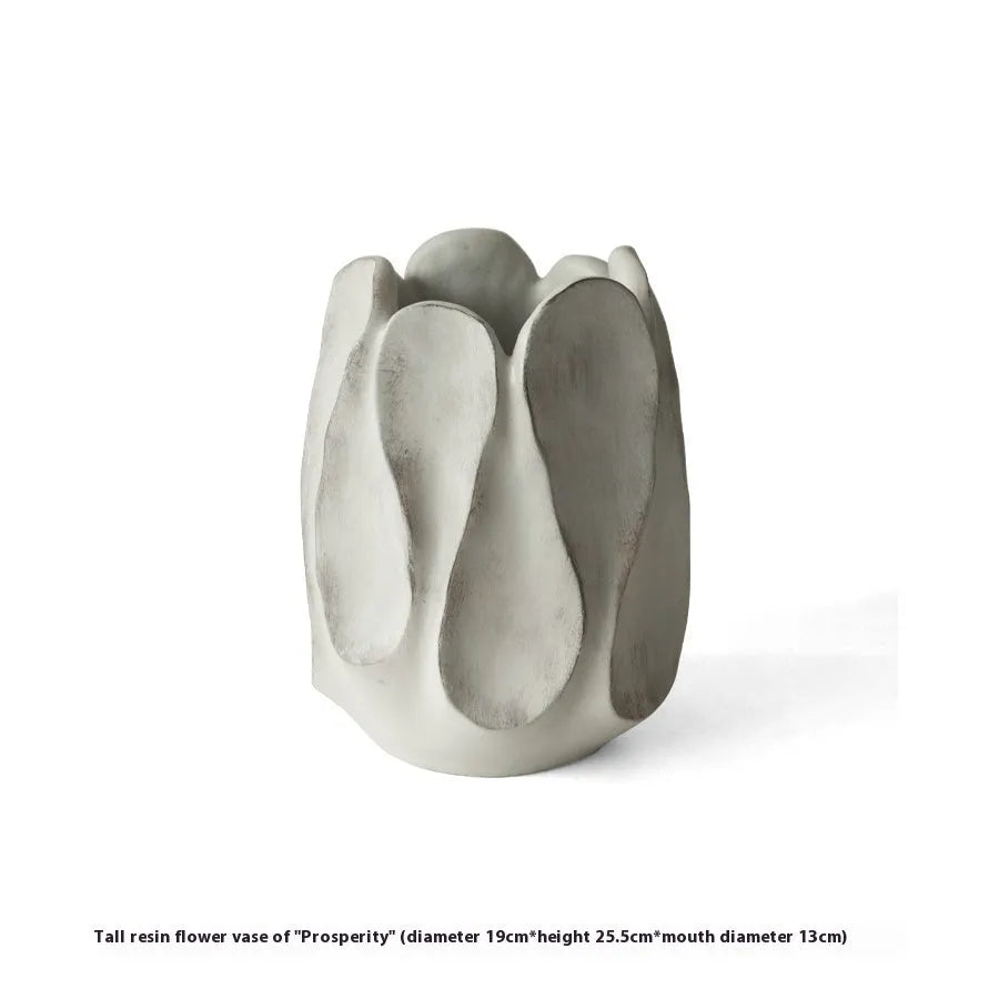 Handmade irregular ceramic vase in magnesium clay on a wooden surface.