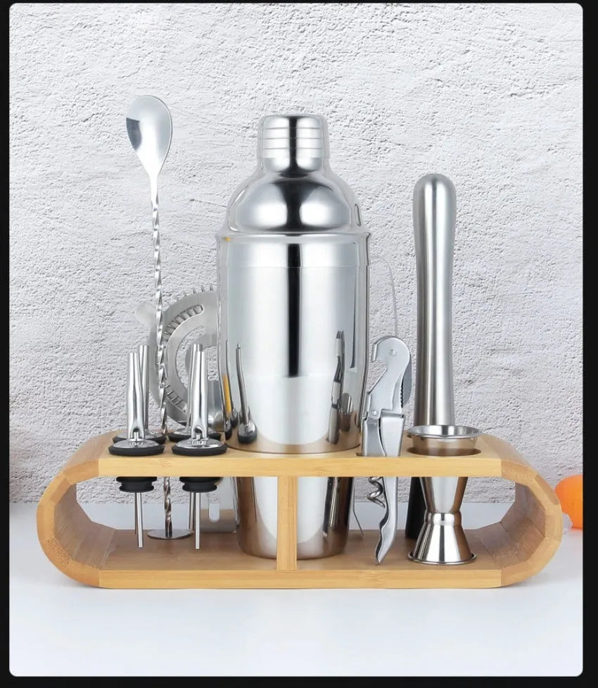 23-piece stainless steel and acrylic cocktail set with shakers and bar tools on a counter.