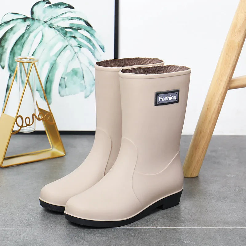 Women's black PVC rain boots with mid-calf height and low heel