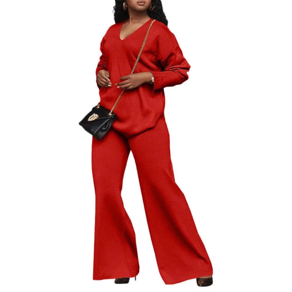 Women's brown suede two-piece suit with split sleeve detail on the long-sleeved top and matching trousers.