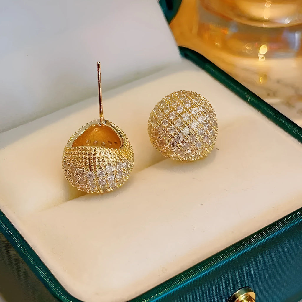 Geometric drop-shaped ear clips with full diamond detailing and sphere elements in gold and white colour options