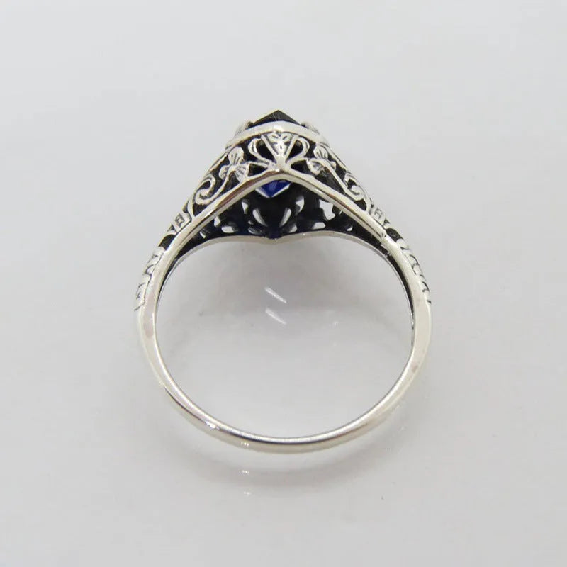 Women's geometric hollow ring in electroplated silver with zircon detail, showing openwork pattern